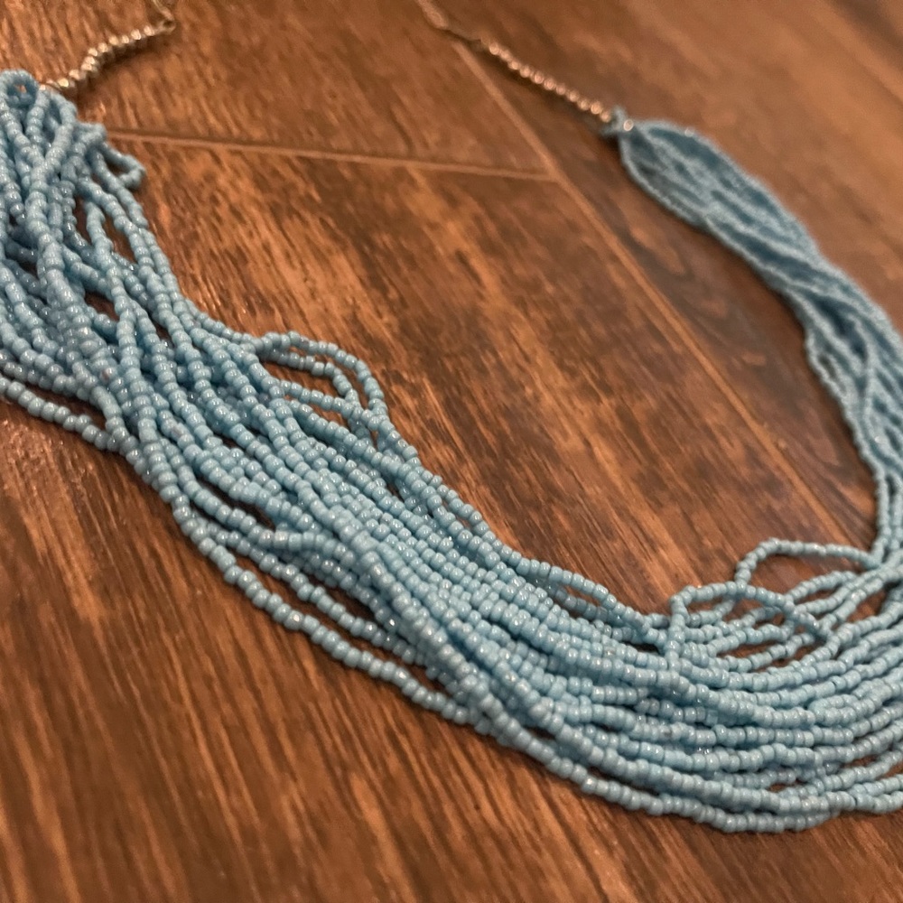 Light blue multiple necklaces in one